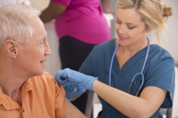 nurse giving a man a flu shot